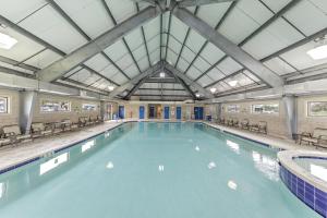 a large indoor swimming pool with blue water at Plantation Dunes Condos in Gulf Shores