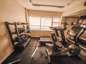 a room with a gym with a treadmill and weights at Sol Ipanema Hotel in Rio de Janeiro