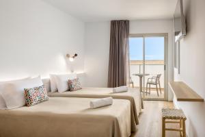 a hotel room with two beds and a balcony at htop Amatista #htopBliss in Lloret de Mar