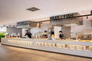 a restaurant kitchen with two chefs preparing food at htop Amatista #htopBliss in Lloret de Mar