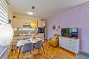 a kitchen and dining room with a table and chairs at Oaza Mira in Zlatibor