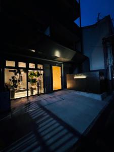 a shadow of a building with a door in the dark at Kyoto ITOYA Hotel Mon in Kyoto