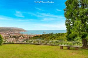 a park bench on a hill with a view of the ocean at Ai Colli 136, Terre Marine in La Spezia