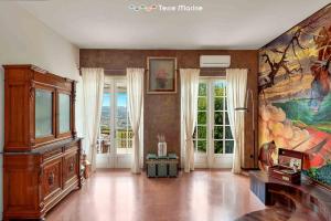 a large room with a large painting on the wall at Ai Colli 136, Terre Marine in La Spezia