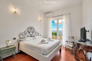a bedroom with a bed and a television and a window at Ai Colli 136, Terre Marine in La Spezia