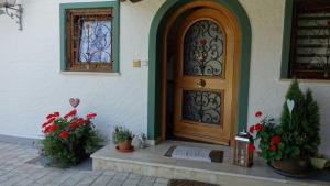 a front door of a house with potted plants at Ferienwohnung Haulle, Kreuth-Scharling am Tegernsee in Kreuth