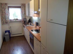 a kitchen with a white refrigerator and a sink at Ferienwohnung Haulle, Kreuth-Scharling am Tegernsee in Kreuth +88 photos