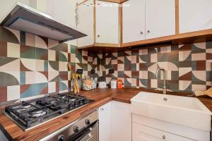a kitchen with a stove top oven next to a sink at Ai Colli 136, Terre Marine in La Spezia +9 photos
