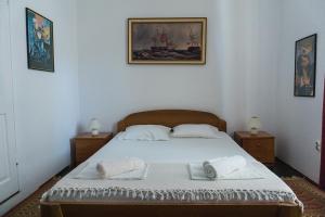 a bedroom with a bed with two towels on it at Giunio house, Old town centre in Korčula