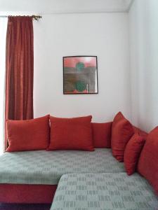 a couch with red pillows in a living room at Giunio house, Old town centre in Korčula
