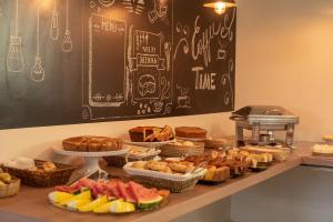 a buffet with various types of bread and pastries at Vidagi Palace Hotel in Nova Serrana