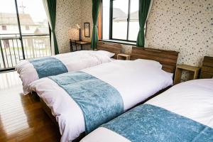 Postel nebo postele na pokoji v ubytování Villa228KASAMA