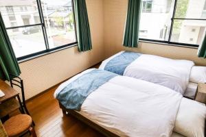 Postel nebo postele na pokoji v ubytování Villa228KASAMA