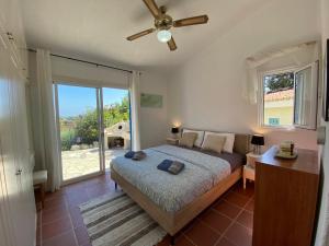 a bedroom with a bed and a large window at Mediterranean Cottage, Sea View, Great Location in Chlorakas