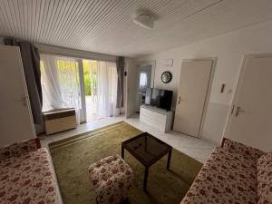 a living room with a couch and a table at Sunny Clara Önálló Nyaraló in Siófok