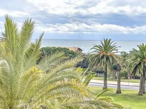 a group of palm trees in front of the ocean at 3 Bed Beach Apartment with views Isla Canela in Isla Canela