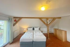 a bedroom with a large bed in a room at Haus Antje Studio in Kölpinsee