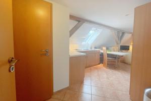 an open door to a kitchen with a sink at Haus Antje Studio in Kölpinsee +11 photos