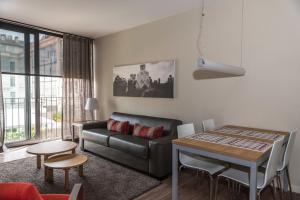 a living room with a couch and a table at Casp 74 Apartments in Barcelona