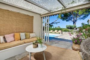 un soggiorno con un divano e un tavolo di Bastide des Sarrières à -d'1 km de Lourmarin - Piscine chauffée, cuisine d'été, pool house, sauna a Lourmarin