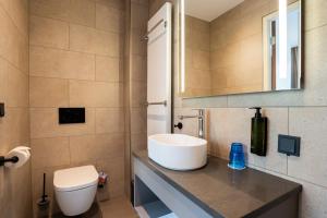 a bathroom with a sink and a toilet at Hotel Kontakt der Kontinenten in Soesterberg