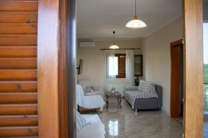 a living room with two couches and a table at Theros in Makrygialos +33 photos