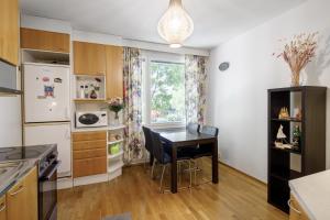 a kitchen with a small table and a window at Helsinki Green Retreat in Helsinki +9 photos