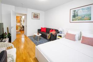 a white bedroom with a bed and a couch at Helsinki Green Retreat in Helsinki