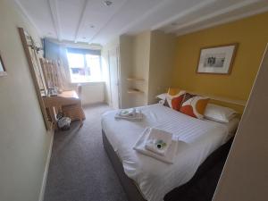 a hotel room with a bed with a tray on it at The Countryman’s Inn in Hunton