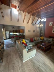 a living room with a couch and a table at Casa de campo El Valle Inn in Lima