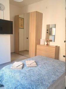 a bedroom with a bed with two towels on it at Magh1 in Parma