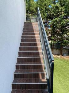 a staircase leading up to a building with a fence at Ideal Apartment For 4 By Marseille Airport in Marignane