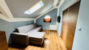 a living room with a couch and a window at Apartament Zacisze Vip in Złotów +12 photos