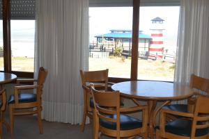 a dining room with tables and chairs and a lighthouse at Hotel Montecarlo in Villa Gesell