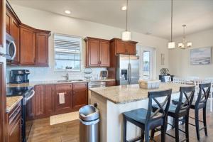 a kitchen with wooden cabinets and a island with bar stools at 10333 Monticello Dr in Port Charlotte