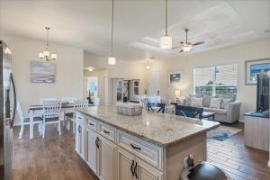 a kitchen and living room with a table and a couch at 10333 Monticello Dr in Port Charlotte +87 photos