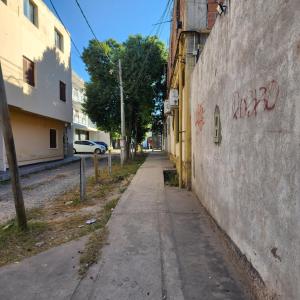 an alley with graffiti on the side of a wall at Departamento equipado, centrico, cochera cubierta Sarmiento265apart D13 in San Fernando del Valle de Catamarca
