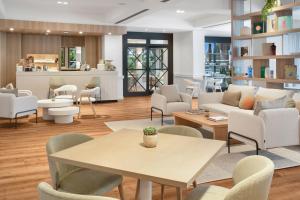 a living room with a table and chairs at Meliá Lloret de Mar in Lloret de Mar