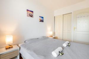 a bedroom with a bed with two towels on it at GuestReady - A Spacious apt near Eiffel Tower in La Défense