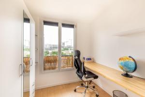 a home office with a desk and a chair at GuestReady - A Spacious apt near Eiffel Tower in La Défense