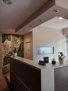 an office with a reception desk with a wall at Hotel Luis III in Mar del Plata