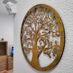 a wooden circle with a tree on a wall at Apartamento Playa Tanguillos del Mar in Cádiz