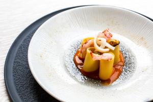 a white plate with food on a table at Zen Hotel Versilia in Marina di Pietrasanta
