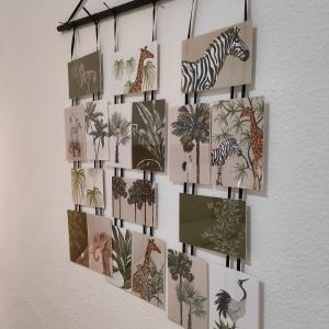 a wall with pictures of animals and plants on it at Apartamento Playa Tanguillos del Mar in Cádiz
