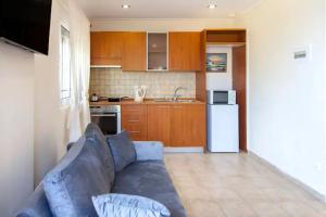 a living room with a blue couch in a kitchen at Villa Anna in Athani
