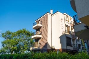 a building with balconies on the side of it at Dion Apartments in Lozenets