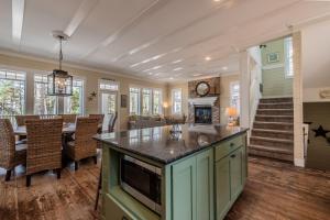a kitchen and dining room with a table and a fireplace at Nantucket House by Seabrook Hospitality in Pacific Beach +60 photos