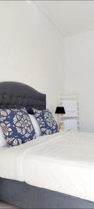 a bed with blue and white pillows on it at CELEBRITY Hotel in Argostoli