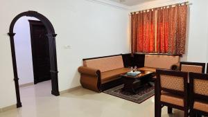 a living room with a couch and a table at Dahlia Sohar Hotel Apartments in Sohar