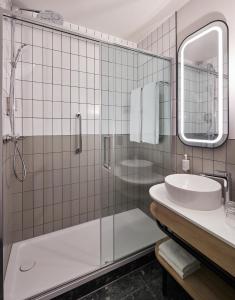 a bathroom with a shower and a sink at Leonardo Hotel Dublin Parnell Street in Dublin